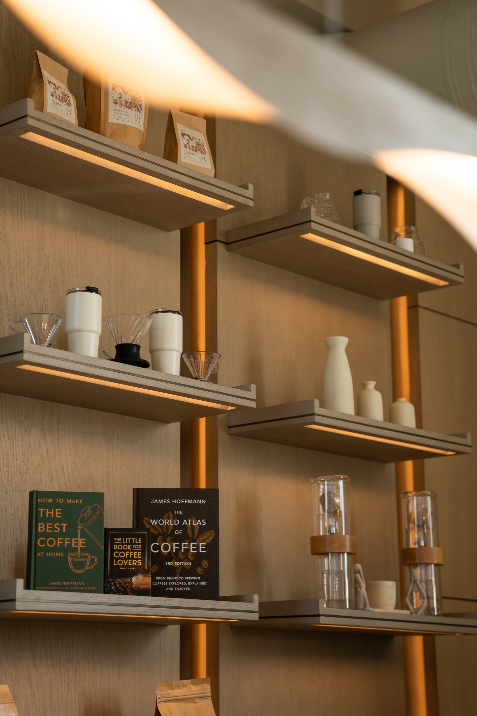 Brew shelves with coffee beans, books and brewers